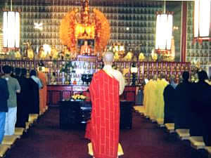 The Abbot leading the assembly in the Buddha Hall